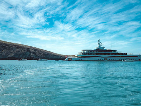 Small luxury ship anchored in a turquoise Mediterranean bay