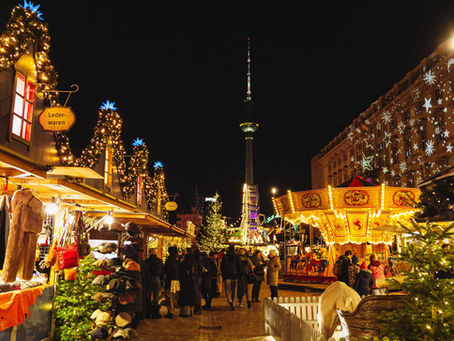 Festive Christmas market at night with illuminated wooden stalls and fairy lights in Berlin, Germany – Christmas markets cruise inspiration