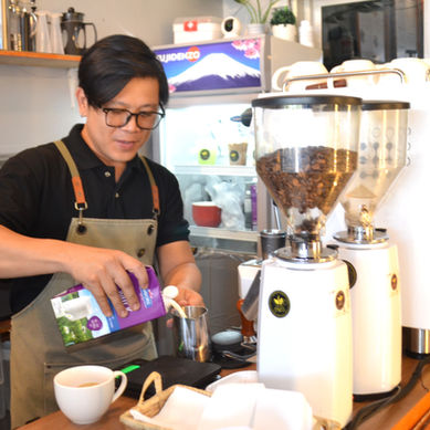 A barista preparing a coffee drink