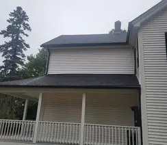 Full exterior remodeling with rubber roof and vinyl siding installation in Wayland, MA.
