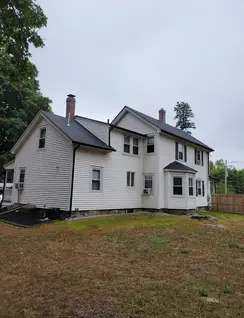 Full exterior remodeling with roof and siding repair in Westford, Massachusetts.