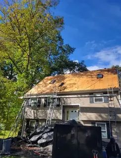 Asphalt roof installation and vinyl siding repair by roofing contractor in Waltham, MA.