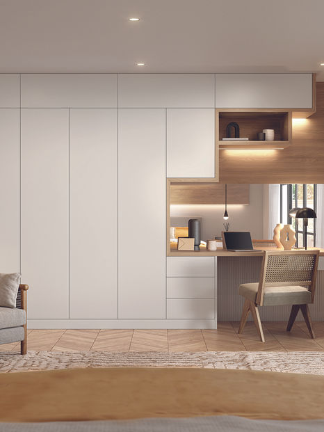Modern bedroom with white handleless wardrobes, wooden accents, and a built-in desk area beside a window.