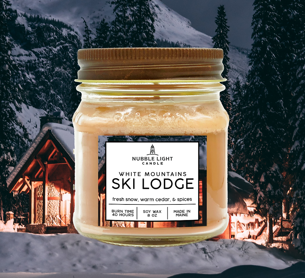 An 8oz. White Mountains Ski Lodge scented soy candle from Nubble Light Candle with a snowy ski lodge in the background