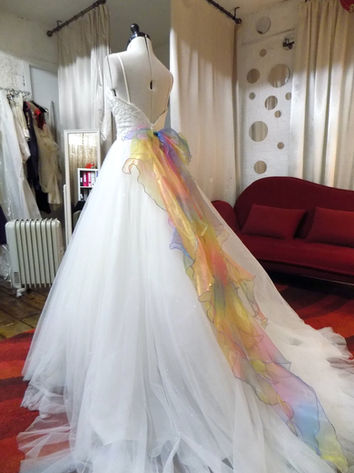 Upcycling a wedding dress adding a handmade rainbow bow and hundreds of crystals.