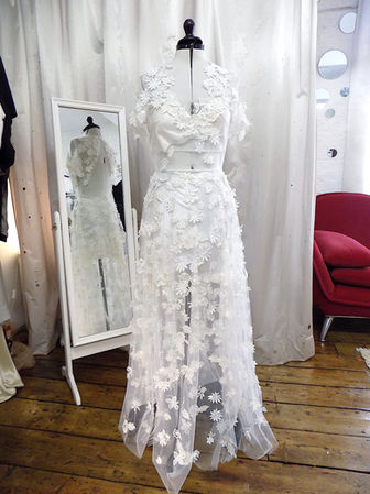 Paula wanted to incorporate into her bespoke wedding gown a beach dress that had sentimental value for her. Her gown was built around it and then embellished by hand with hundreds of hand-cut and sewn guipure lace flowers, over an illusion tulle base.
