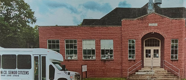 Red brick building with van parked in front
