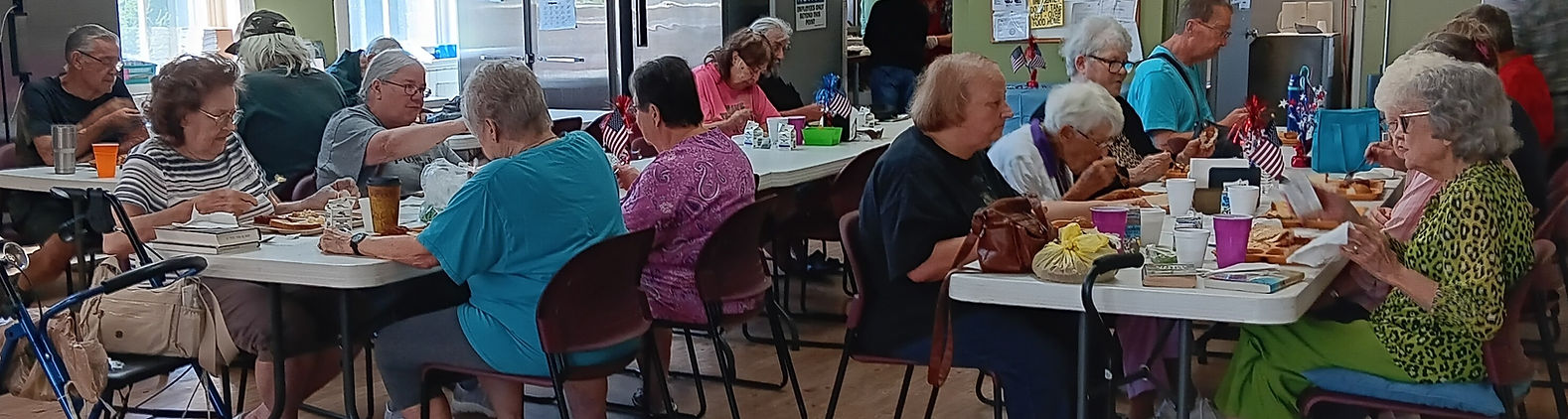people eating at long tables