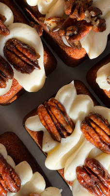Small Spice Cakes Accompanied with Cream Cheese Frosting and Candied Pecans