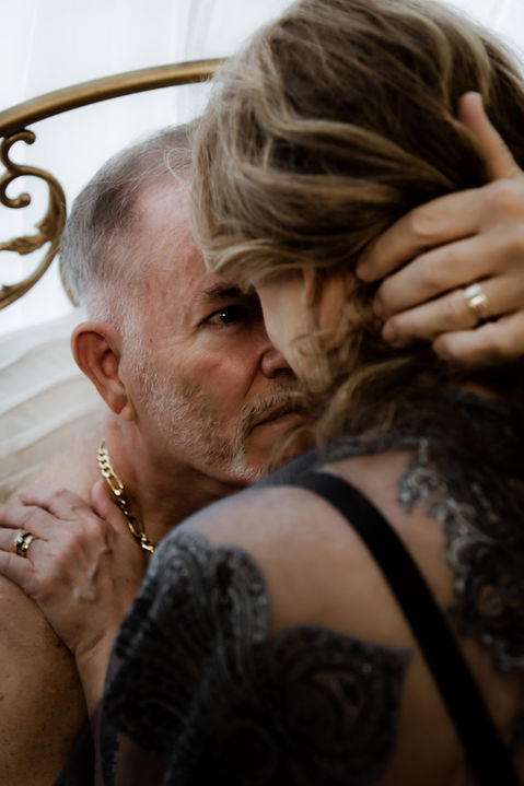 Close up of a couple touching their foreheads together and looking into each others eyes.