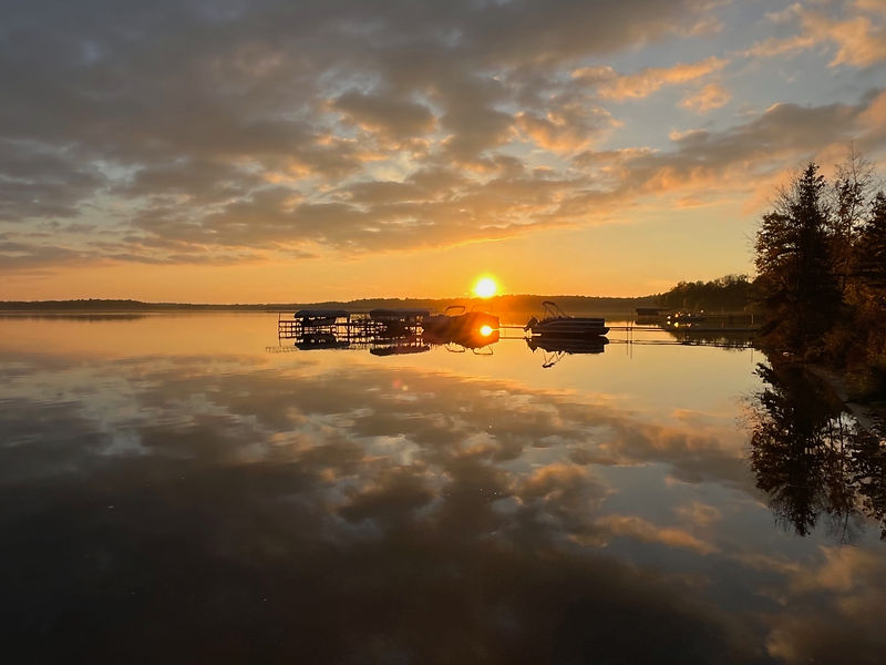 Sunset over Kitchi Lake with boats at the docks at Kitchi Landing Resort on the Cass Lake Chain in Minnesota