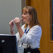 Presenter speaking and gesturing during a workshop session.