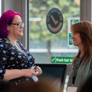 Attendees talking in a networking area.