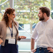 Attendees networking and talking in a breakout area.