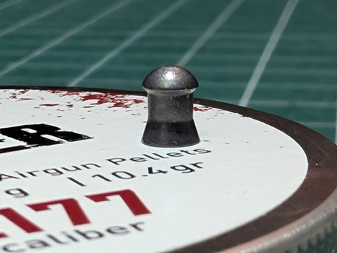 JTS Dead Center Heavy 10.4gr .177 Pellets Profile and shape being shown in a macro photo of the pellet standing on its tin