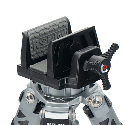 Close-up of gun clamp mounted to tripod head, showing locking mechanism