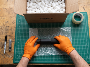 rolling a silencer in bubble wrap ready for postage