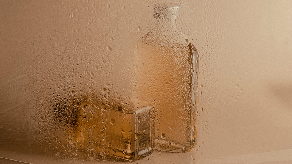 Beauty products through a wet steamy window
