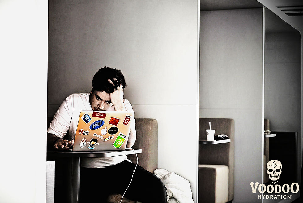 stressed guy at a table with his computer
