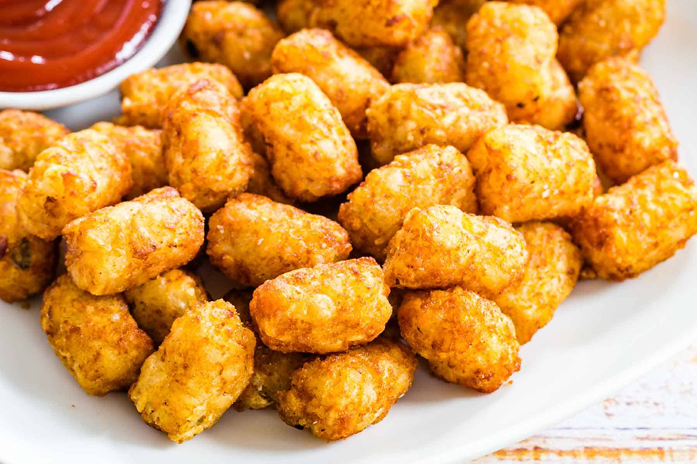 a plate full of great value taters with ketchup