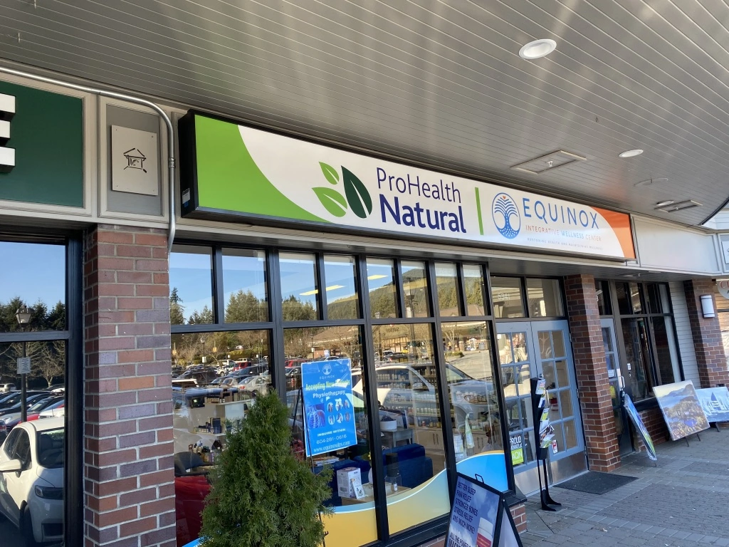 A storefront view of Pro Health Natural with the focus on their lightbox sign