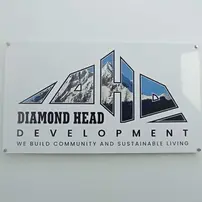 Printed acrylic sign for Diamond Head Development that is mounted on an office wall using standoffs