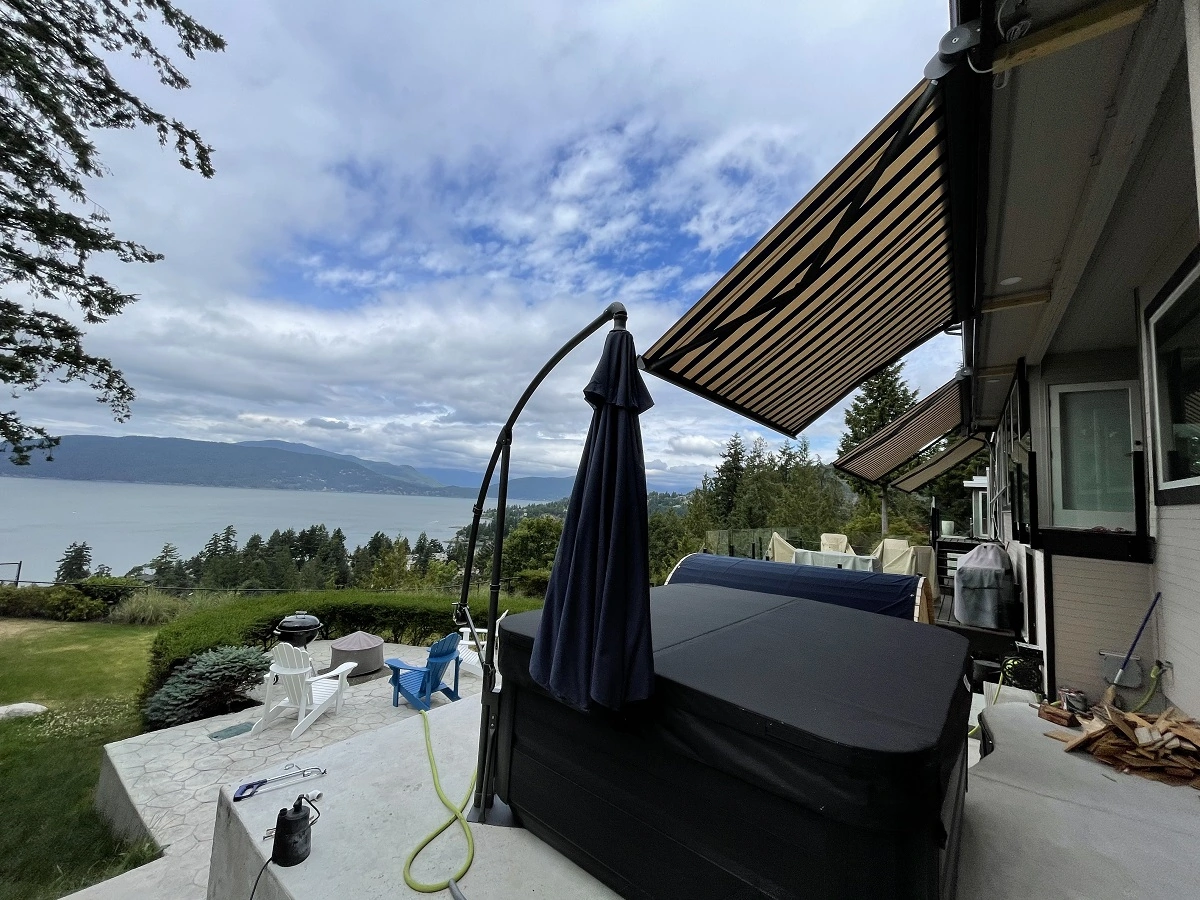 A view of the look from a house atop a hill with its retractable awnings pulled out.webp
