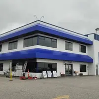 Blue colored awning covering the facade of Convoy Supply Head office in Surrey