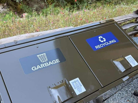 Garbage and Recycle vinyl decals placed on different bins at Squamish Canyon