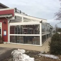 Patio enclosures made out of clear plastic walls covering a restaurant patio in winter