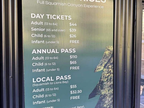 A coroplast printed sign with ticket prices installed at the ticket booth at Squamish Canyon