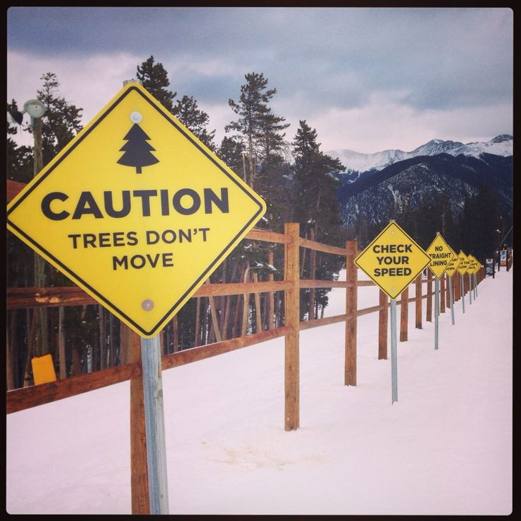 Safety signs that reads caution at a ski resort