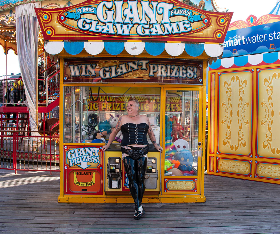 Fat white woman in leather corset and latex stocking smiling in front of the "Gian Claw Machine" at Fisherman's Wharf, San Francisco