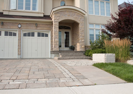 Estate-style interlock driveway leading to a formal front entrance by Horvath Landscapes