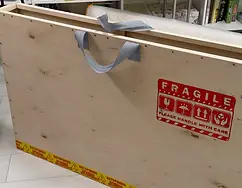 Hand-built plywood shipping box crafted by artist Yana Evans to safely package and protect original artwork for international delivery