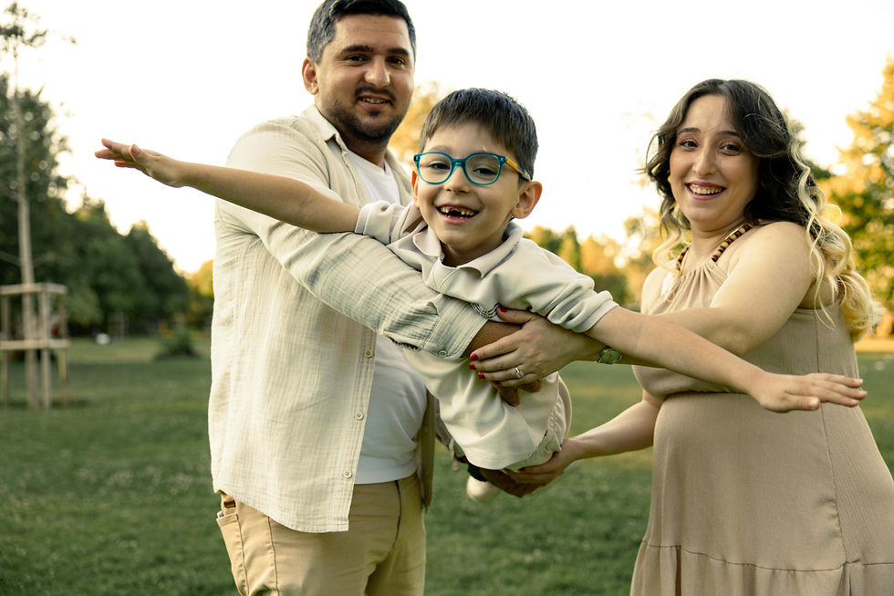 a happy autistic child playing with his parents