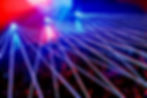 Vibrant blue and red laser light show over a concert crowd