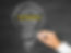 Handwriting "facilitation" and related words in a light bulb shape on a blackboard. Words include "capacity building," "conflict resolution."