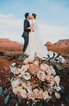 Moab Bride and Groom kissing with flowers