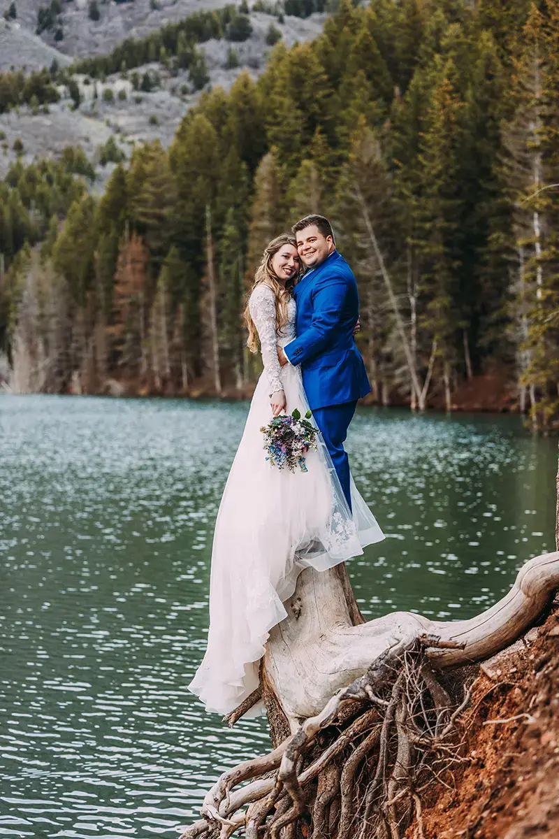 Bride and groom at Tibble Fork Reservoir in Spring with pine trees | Utah Wedding Photographer