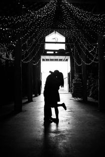 Silhouette of couple in barn at schilter family farm