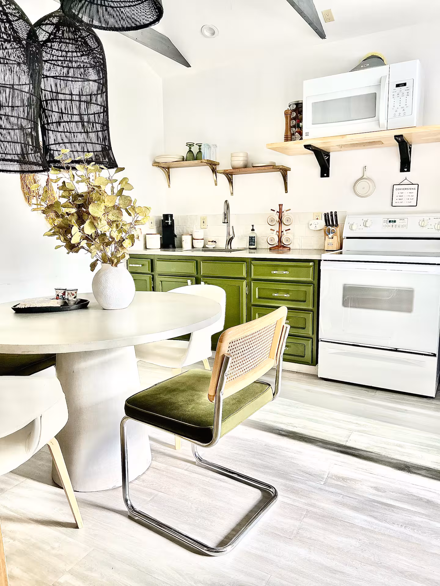 A vintage-inspired kitchen featuring green cabinetry, a farmhouse-style sink, and rustic wooden accents, offering a unique setting for creative photography