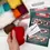 Thumbnail: overhead view of coloured wools and instructions for this kit
