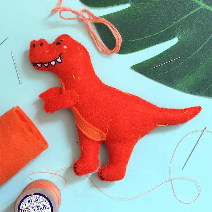 Side view of a red felt T.Rex dinosaur