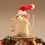 Thumbnail: White mouse holding a bauble and wearing a santa hat standing on piece of wood