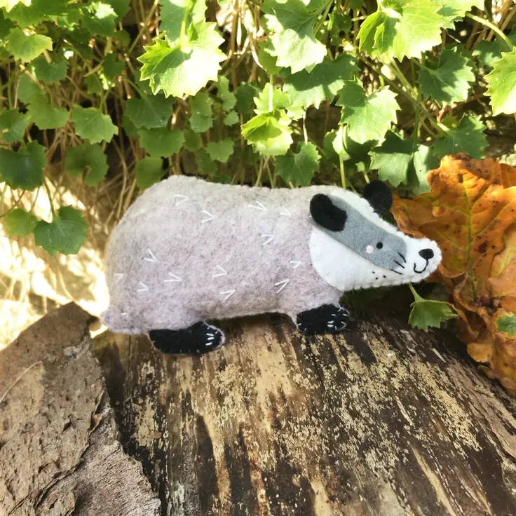 Side view of a felt badger on a log