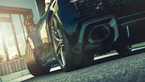 Modern Exotic Performance Vehicle Driving Ground Level Point of View. Lower Part of the Ve