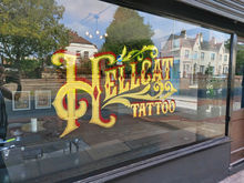 Gold gilded window, tattoo studio, tattoo studio window