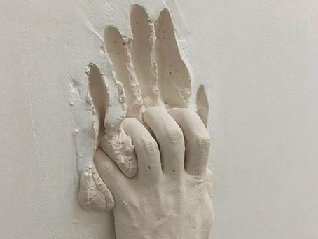 Sculpted hands reach outward, symbolizing the concept of breaking free through the lens of object-oriented programming and inheritance.