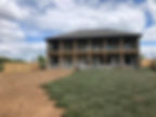 Professional sod installation in progress behind a residential property